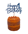 Small cake with sweet potato frosting and a 'Happy 1st Birthday' topper on a white background
